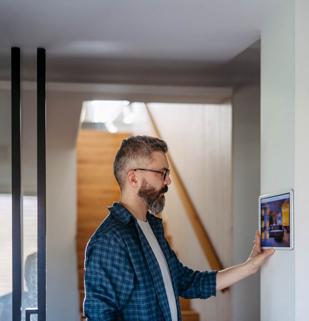 Ein Mann mit einer Wärmepumpe in Herford bedient sein Smart Home